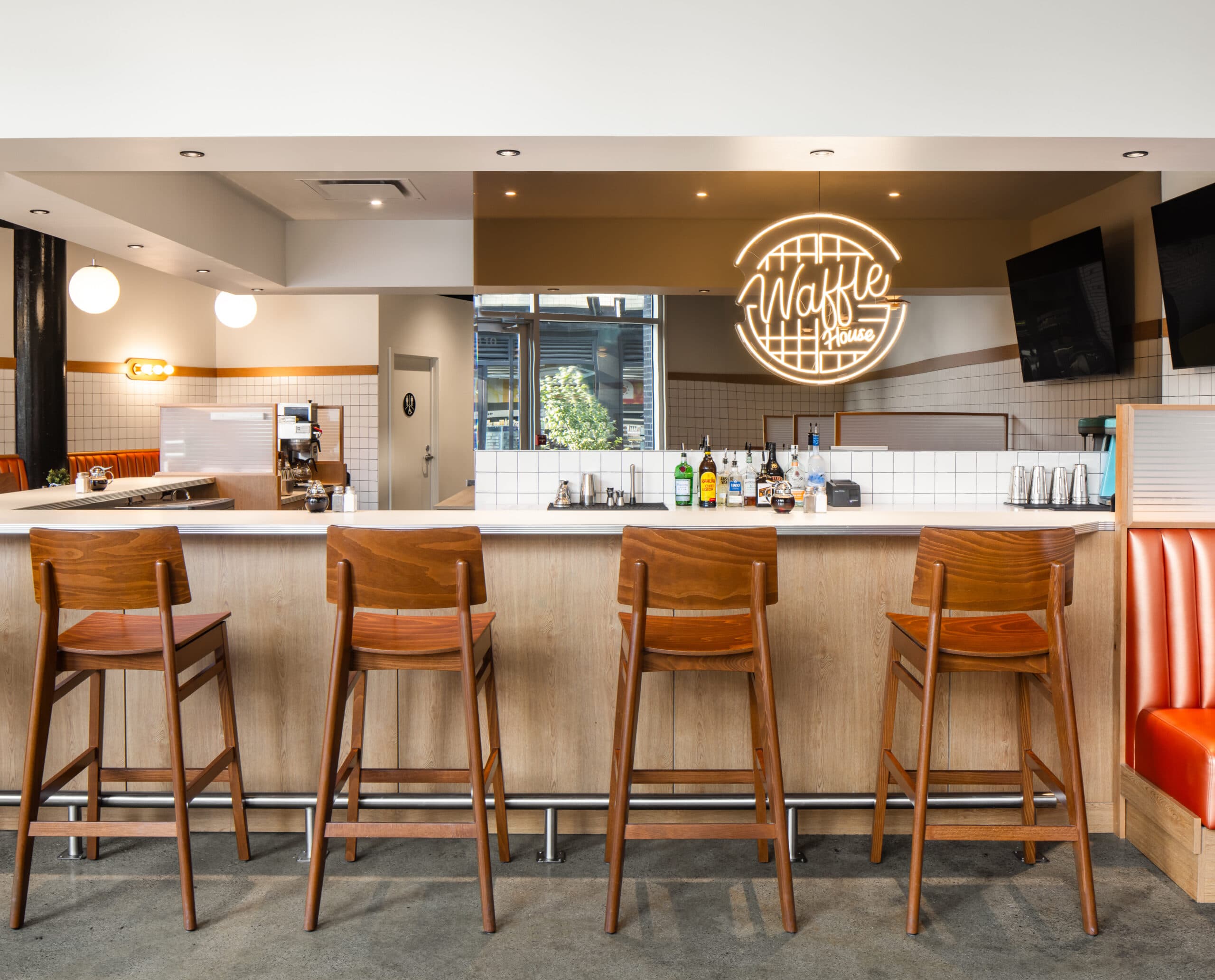 The counter and open kitchen with the waffle logo on the wall