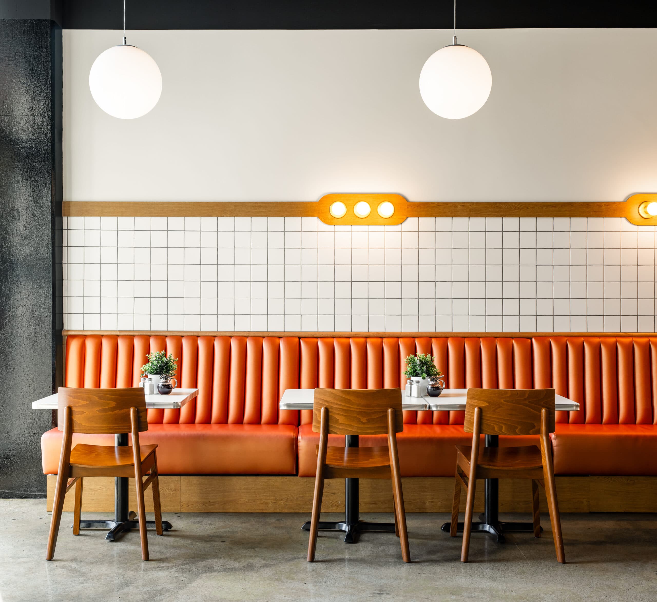 Waffle House Diner dining room with terracotta booths and globe pendant lights
